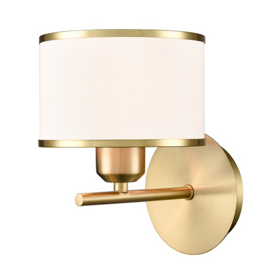 A modern wall-mounted sconce light fixture with a cylindrical white fabric shade, brushed brass metal frame, and a round backplate on a plain white background.